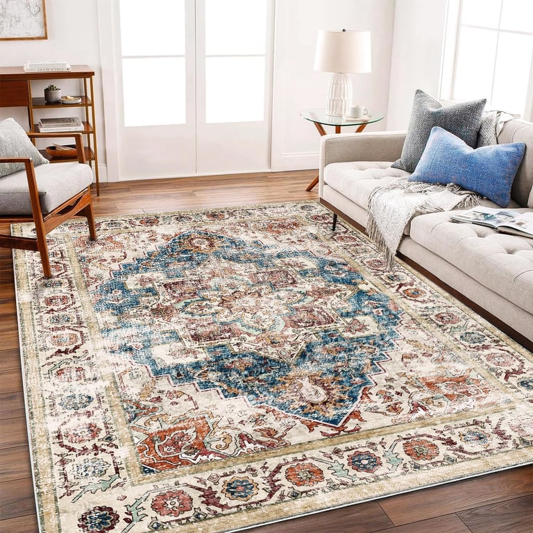 Distressed vintage area rug with blue and orange oriental patterns in a modern living room setting.
