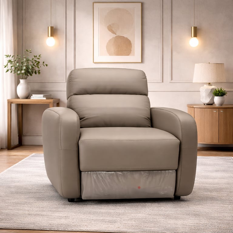 Modern taupe leather power recliner chair in a minimalist living room with neutral decor.