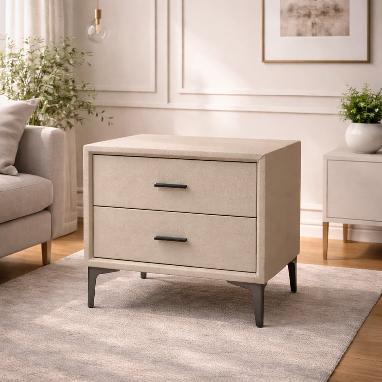 Modern cream faux-shagreen nightstand with two drawers and black metal legs on a neutral area rug.