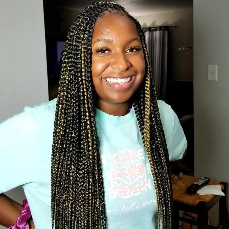 a woman with black and gold box braids