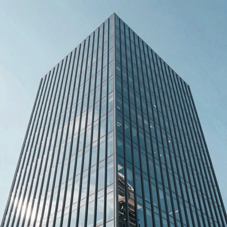 A low-angle shot of a modern glass office tower reflecting a clear light blue sky, representing corporate stability.