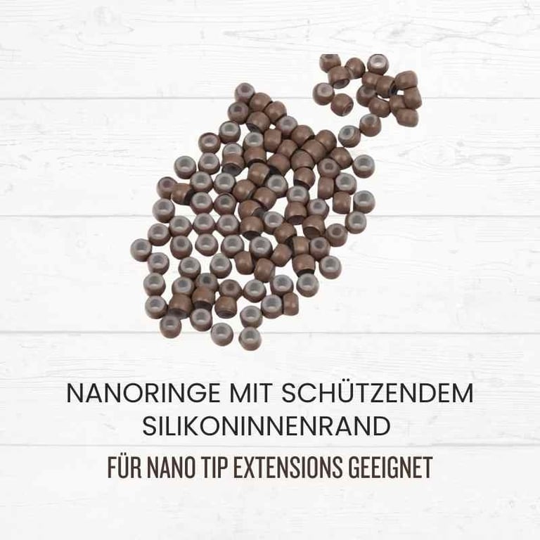 Brown silicone-lined nano rings for nano tip hair extensions on a white wood background.