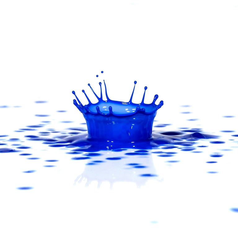 A splash of blue paint on a white surface