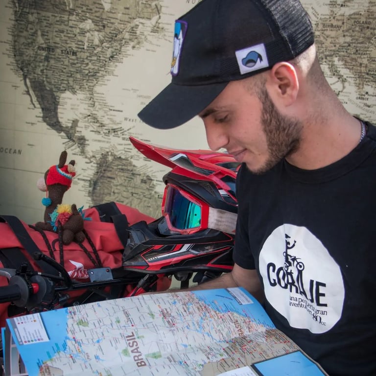 a man in a black shirt and a map of a motorcycle