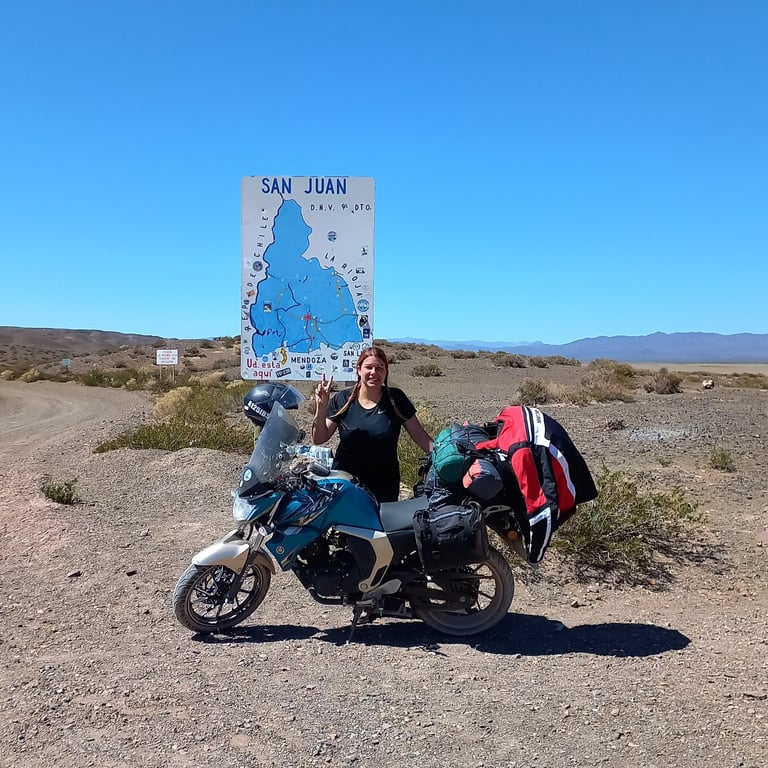a woman standing next to a motorcycle with a map of the world