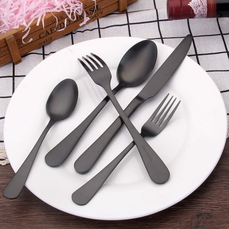 a plate with spoons and forks on a table