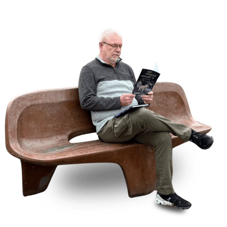 Stephen Ahokas sitting on a bench reading his book