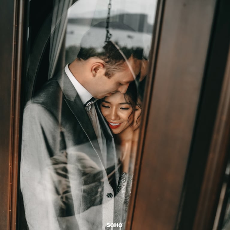a bride and groom standing in front of a door