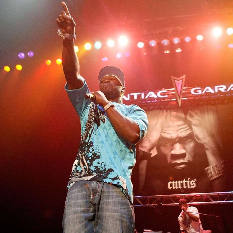 Rapper 50 Cent performing live on stage with a microphone during his Curtis album concert tour.