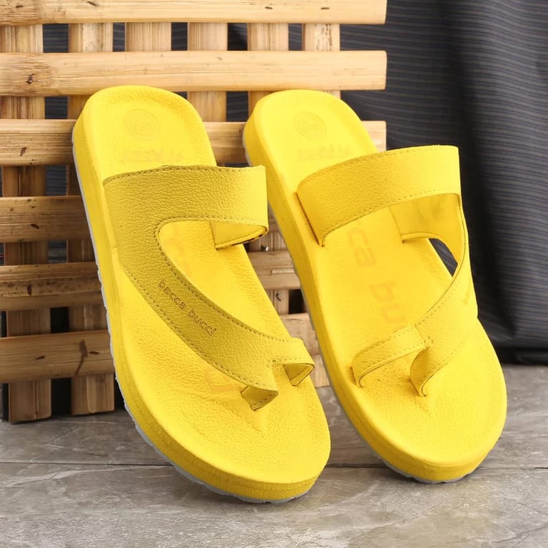 a pair of yellow sandals with a yellow strap