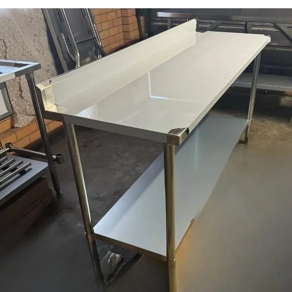 Large stainless steel prep table with splashback and under shelf, available for table hire.