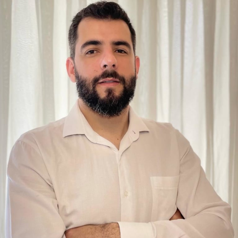 a man with a beard wearing a white shirt