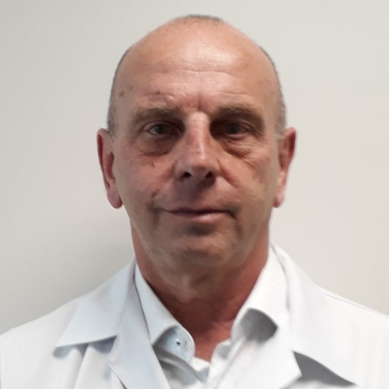 a man in a white lab coat and a white shirt