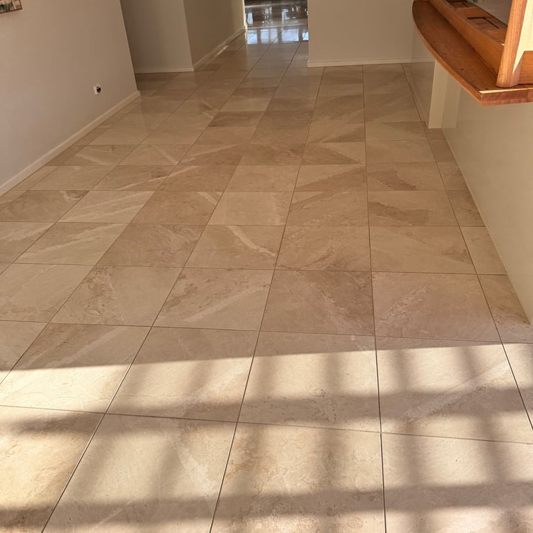 Stone restoration restoring clean, even finish on indoor natural stone flooring.