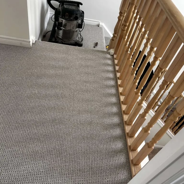 Grey Berber carpet installed in London hallway – textured and durable carpet for high-traffic areas.
