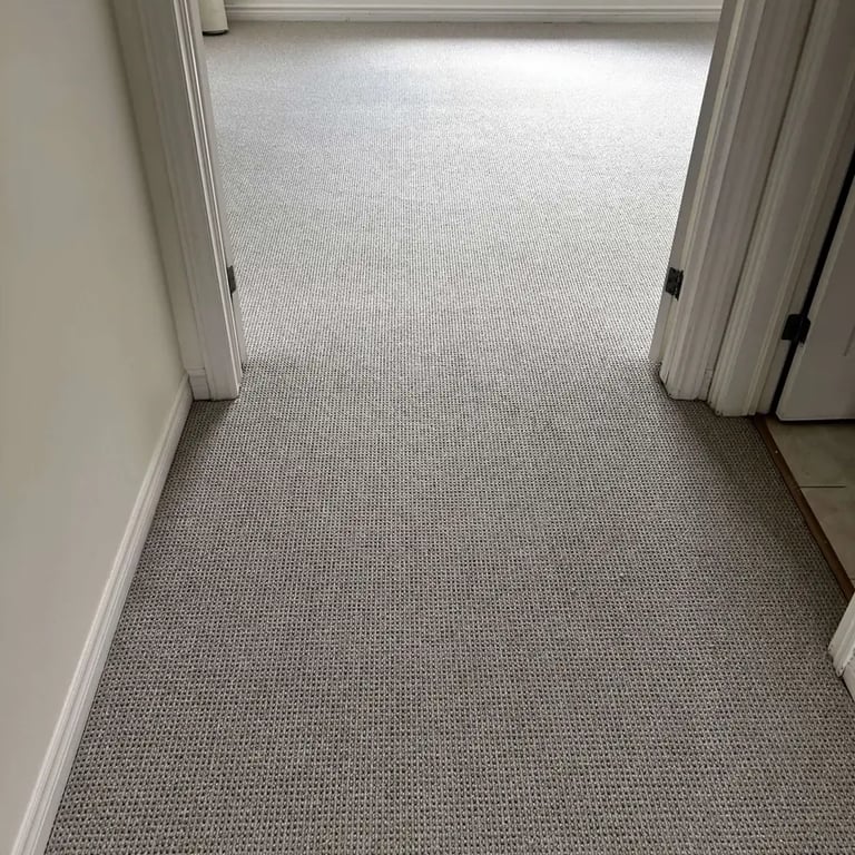 Grey Berber carpet installed in a London hallway – durable and textured carpet for high-traffic areas.
