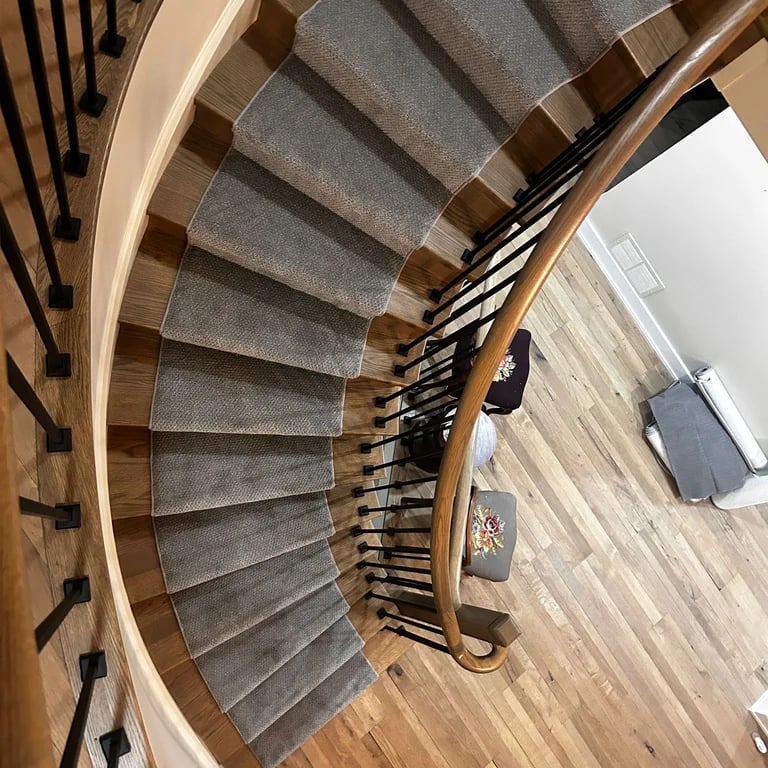 Grey carpet runner installed on hardwood stairs – durable and stylish stair runner in London Ontario home