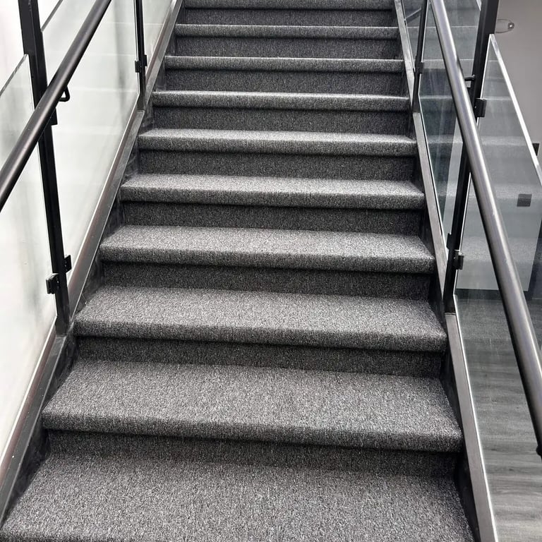 Close-up angle of Academy commercial carpet installed on concrete stairs in London Ontario, durable and slip-resistant floor.