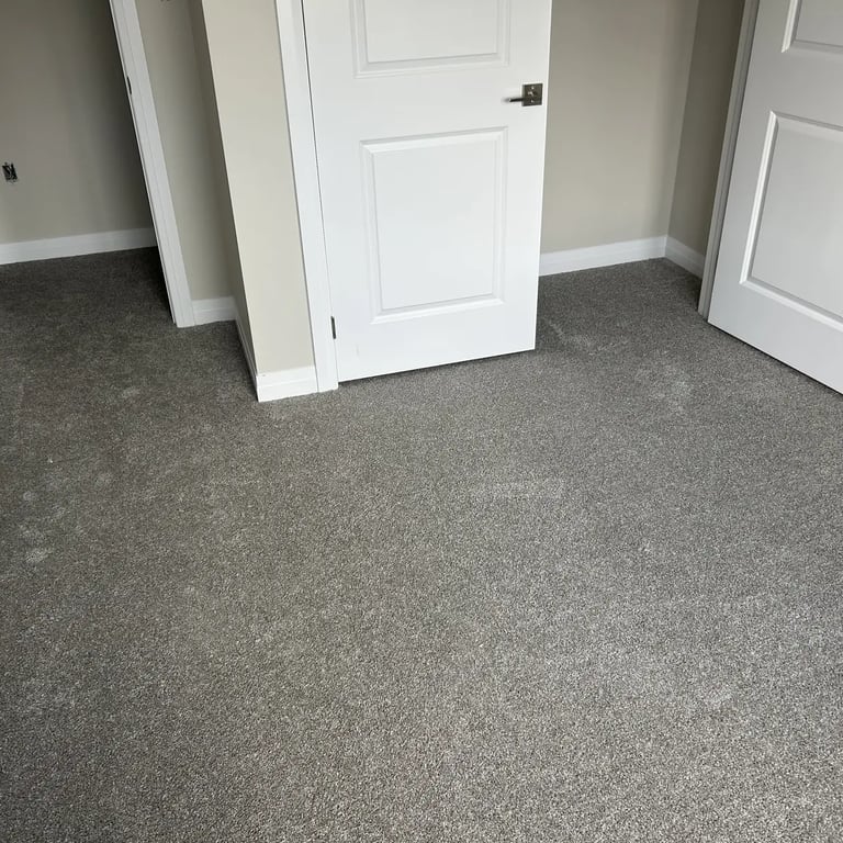 Bedroom with grey plush carpet and carpeted closet side, wall-to-wall installation in Alymer Ontario home