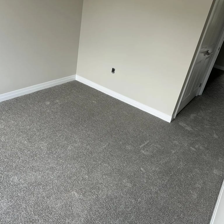 Bedroom with grey plush carpet installed wall-to-wall in Alymer Ontario residential home, soft and comfortable flooring