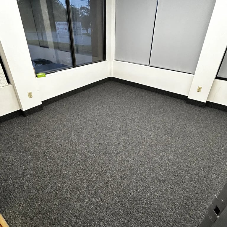 Office room with black commercial carpet installed wall-to-wall in London Ontario, durable and professional flooring
