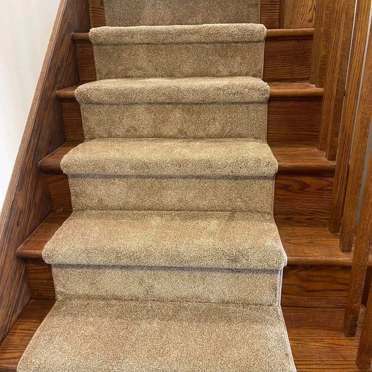 Beige Mcford carpet runner installed on staircase, soft texture with subtle pattern, bordered by hardwood steps