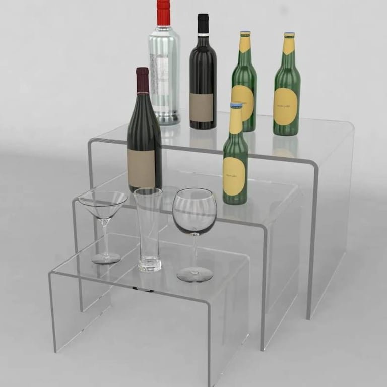 Acrylic risers elegantly presenting wines and glasses, perfect for showcasing and tastings.