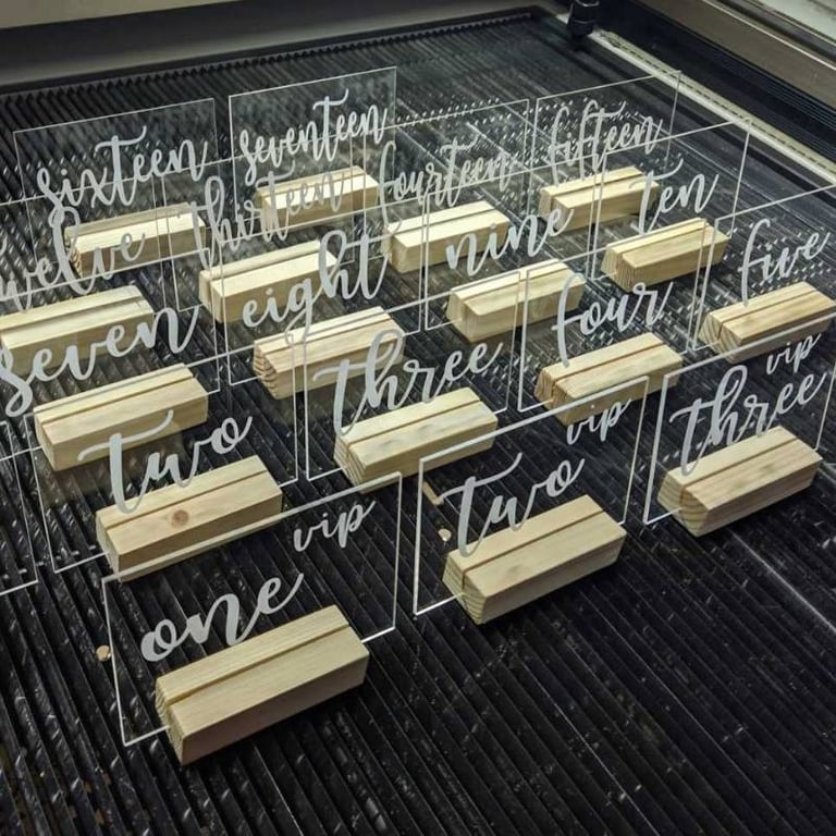 Clear acrylic table numbers with elegant white script numbering from 'one' to 'fifteen,' Rectangular