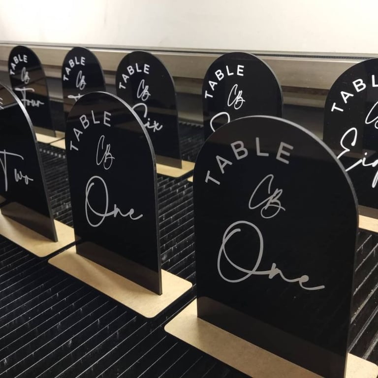 Black Table Numbers oval shaped with text saying Table and the numbers