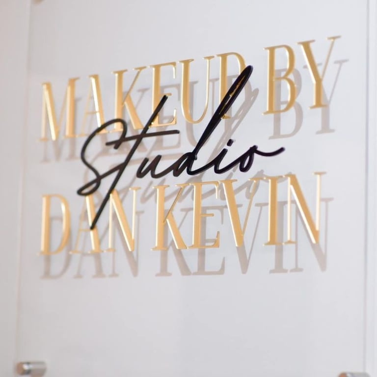 Acrylic Wall Frame with Gold and black text that say Makeup by studio Dan Kevin