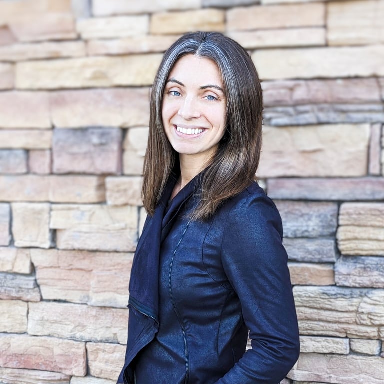 a headshot of Danielle in front of a brick wall