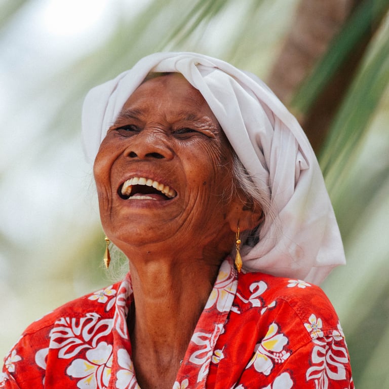 Smiling Mentawai local woman in traditional attire, embodying the warmth of island culture.