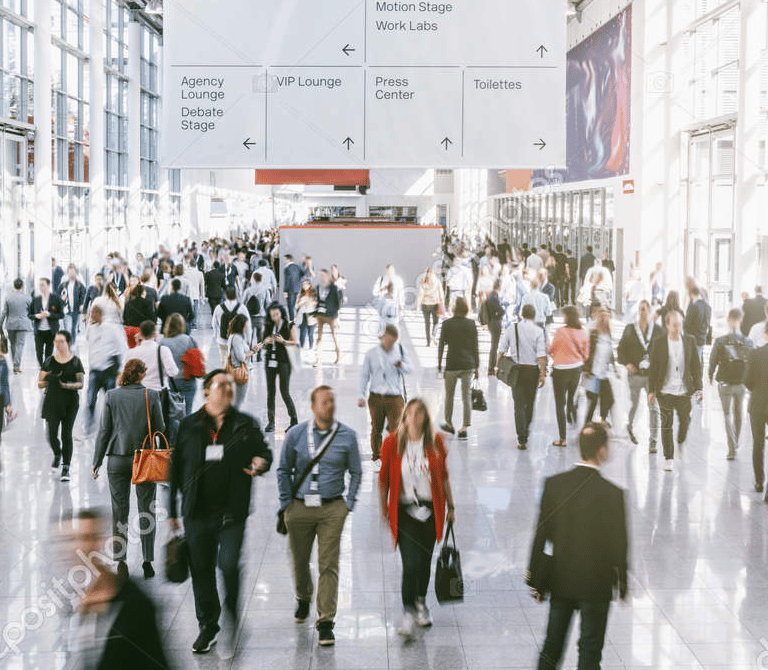 a group of people walking through a busy city