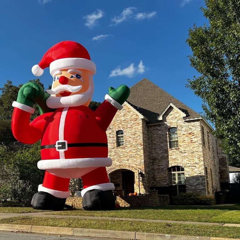 a giant inflatable santa clause in front of a house