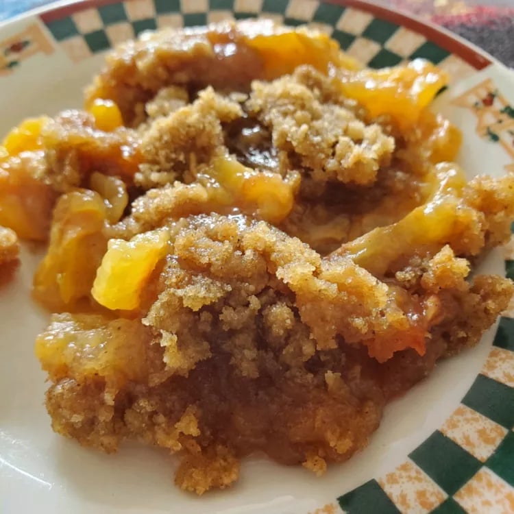 baked crumble dessert of loquats on a plate