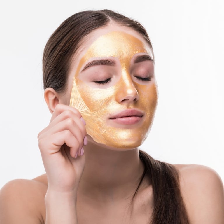 Woman Gold Mask, Beautiful Model with Golden Skin Cosmetic touch Face, Beauty Skincare and Treatment