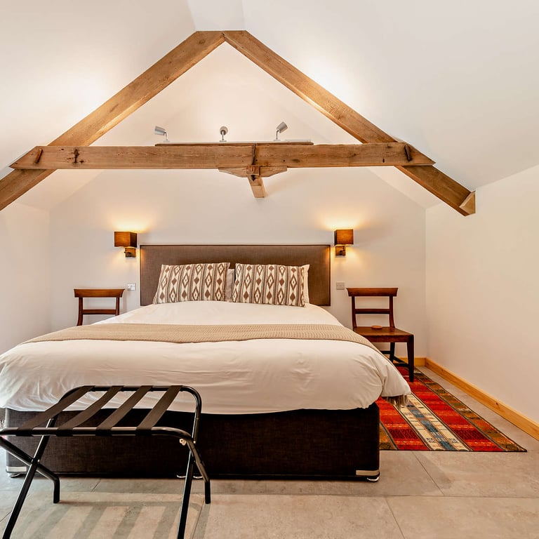 The main bedroom includes a sumptuous superking bed with natural fillings, perfect for a romantic cottage break.