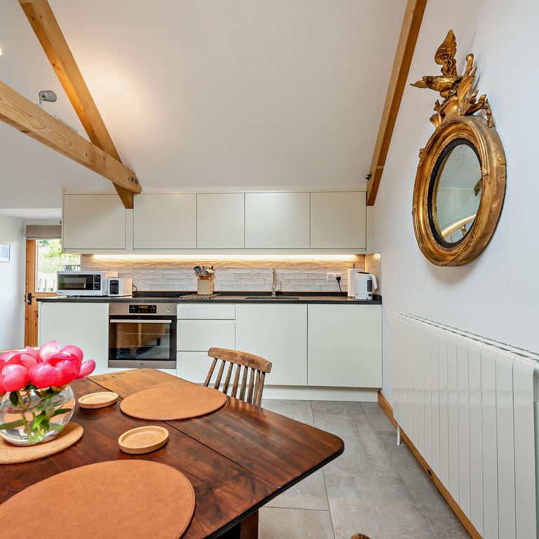 The contemporary kitchen and dining area is  fully equipped for relaxing breaks for couples or for the whole family.
