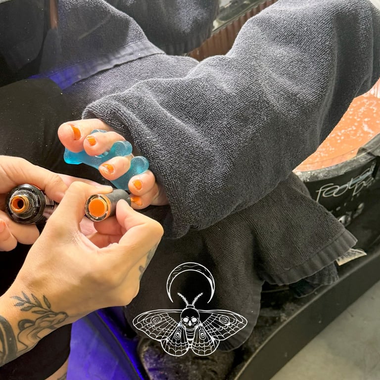 Wet foot full pedicure service with gel orange toe nails by The Nail Witchery