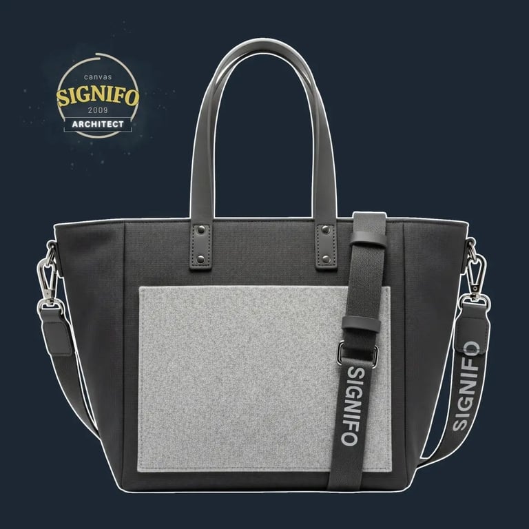 "A highly structured, geometric tote with a rigid, boxy form and sharp, defined corners.
