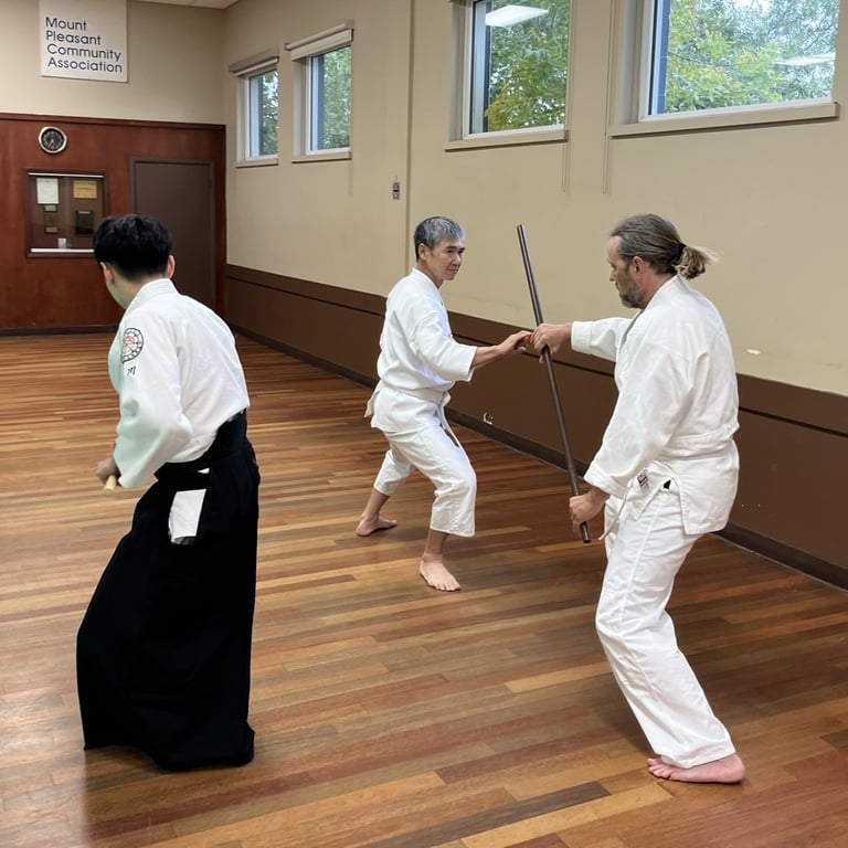 students practicing with staffs