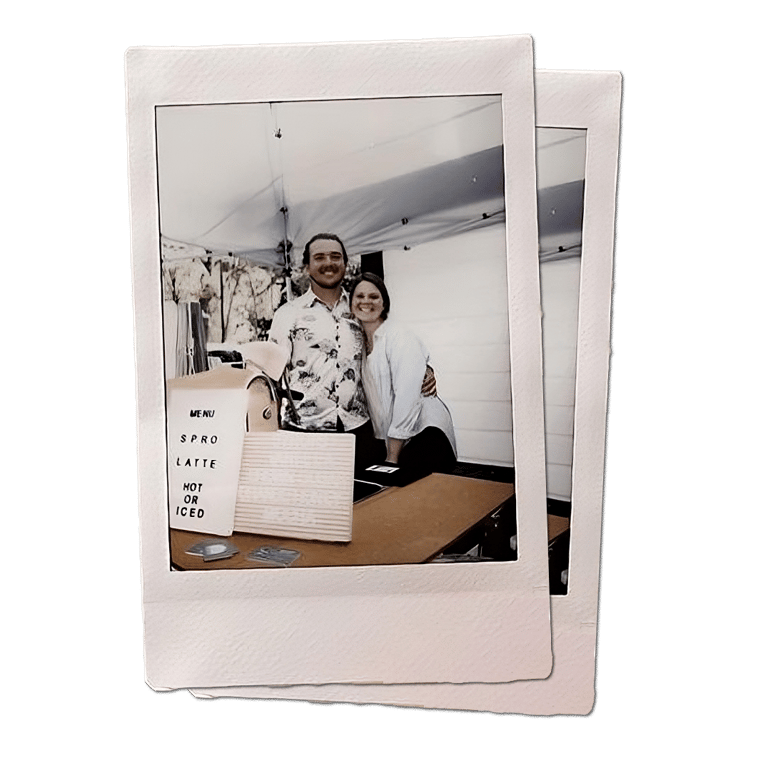 the owners + baristas (tony + sarah) behind their coffee cart and menu