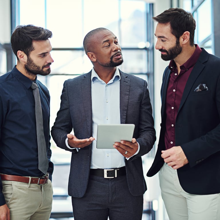 A leader using a tablet to communicate with clarity and influence his team.