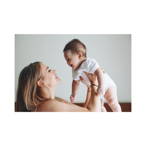 a woman holding a baby in her arms