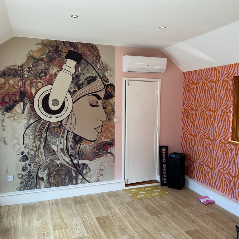 Feature wall wallpaper installation with bespoke mural and wood flooring in a Brighton home