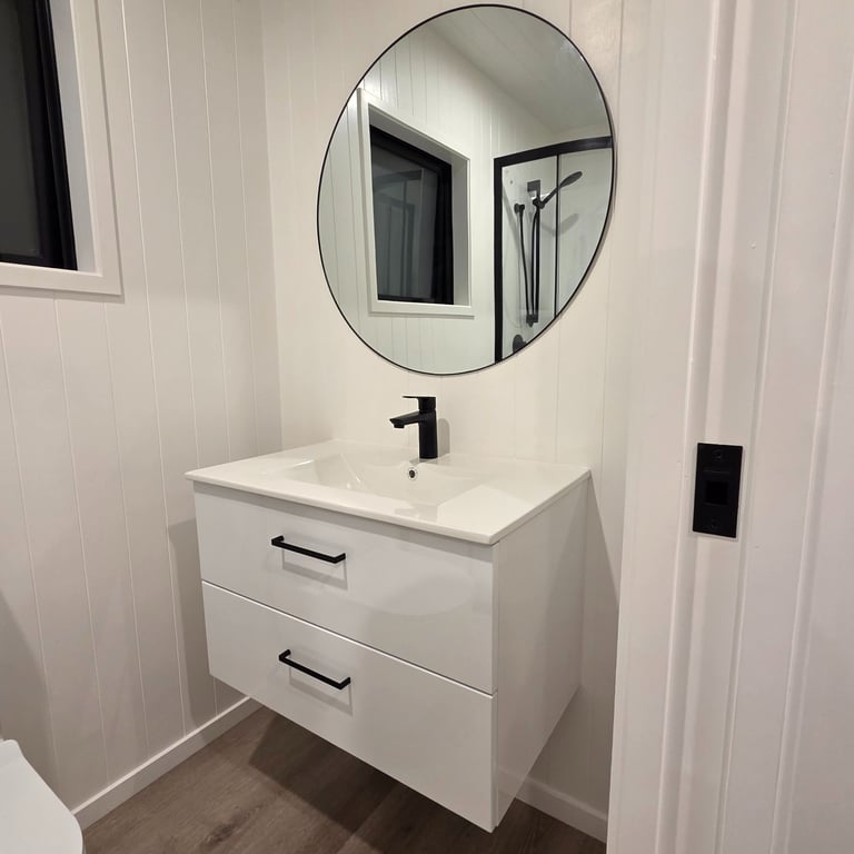 Bathroom vanity with large round mirror