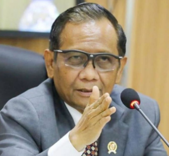 a man in a suit and tie is sitting at a table
