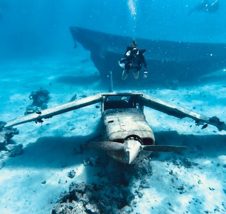 A scuba diver enjoying with a plane wreck