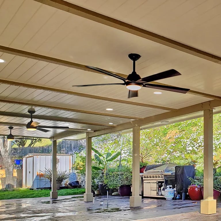Custom wood patio cover creating a beautiful outdoor living space with lights and fans. Located in Escondido, California,