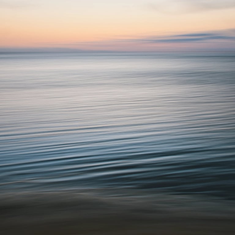 Soft waves shot in ICM on a calm ocean at sunset in Mauritius with gentle pastel hues